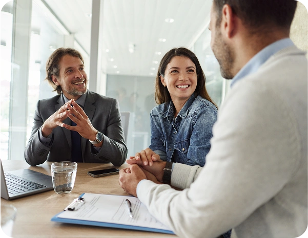 people in a meeting sitting at the conference table