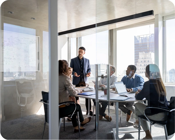 people in a meeting sitting at the conference table